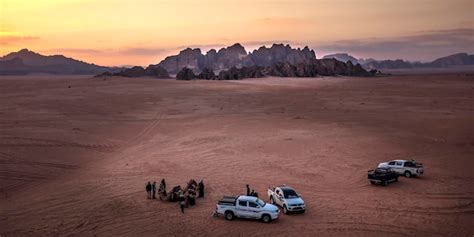 Premium Photo | Tourists in the wadi rum desert at sunset