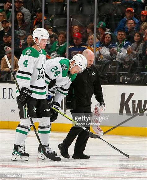 Roope Hintz of the Dallas Stars is helped off the ice after an... News ...