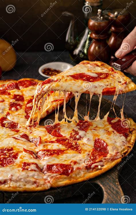 Pepperoni Pizza with a Slice Taken Out with Cheese Pull Stock Photo ...