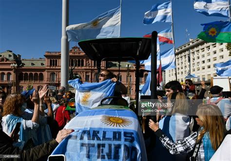 Demonstrators on a tractor hold Argentine flags as they take part ...