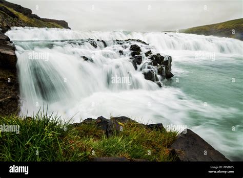 A waterfall in a beautiful Iceland landscape Stock Photo - Alamy