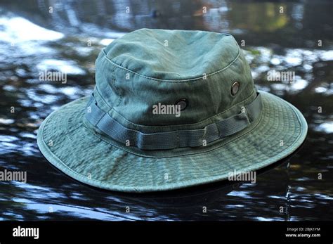 Green military boonie hat on black background Stock Photo - Alamy