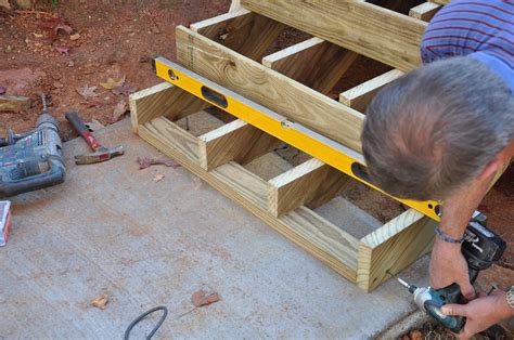 Learn how to anchor your deck stairs to a concrete landing pad or footings. Follow our step by ...