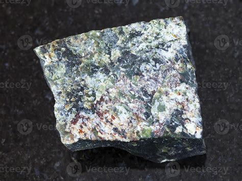 raw dunite stone on dark background 14610788 Stock Photo at Vecteezy