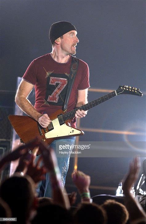 Photo of THE EDGE and U2; performing live onstage on Elevation tour, playing Gibson Explorer ...