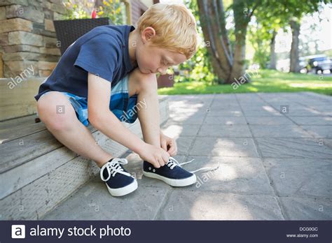 Boy tying shoe hi-res stock photography and images - Alamy