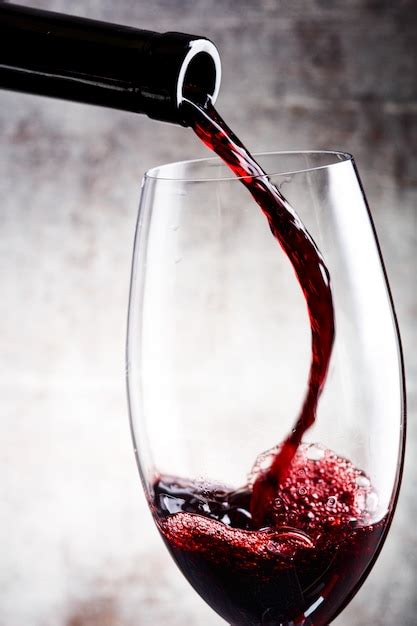 Premium Photo | Pouring red wine into the glass
