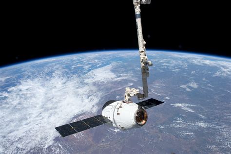 File:ISS-31 SpaceX Dragon spacecraft is grappled by Canadarm2.jpg