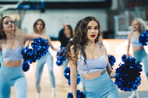 Cheerleaders in Light Blue Uniforms Practicing in the Arena, Medium ...