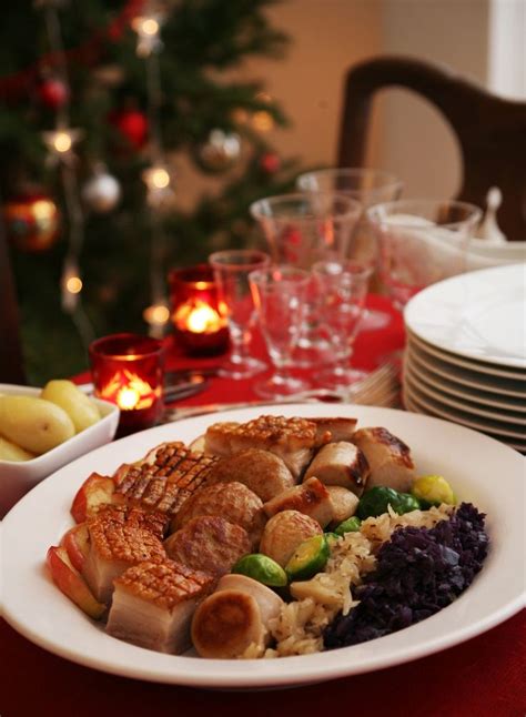 a white plate topped with meat and rice next to plates of food on a red ...