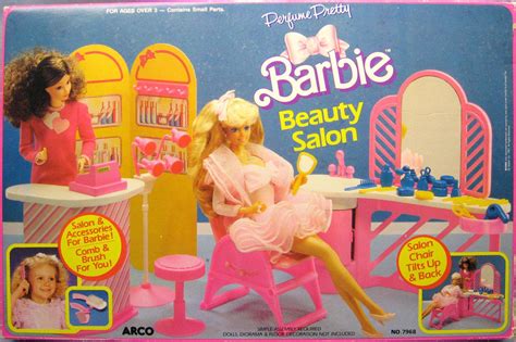 a barbie doll sitting in a pink chair next to a table and vanity with ...