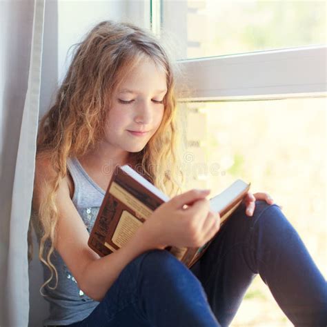 Girl reading book at home stock photo. Image of pupil - 97486442