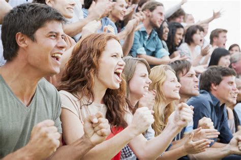 Fans cheering in crowd stock photo