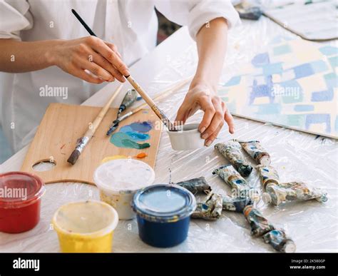 art hobby painting supplies hands mixing paint Stock Photo - Alamy