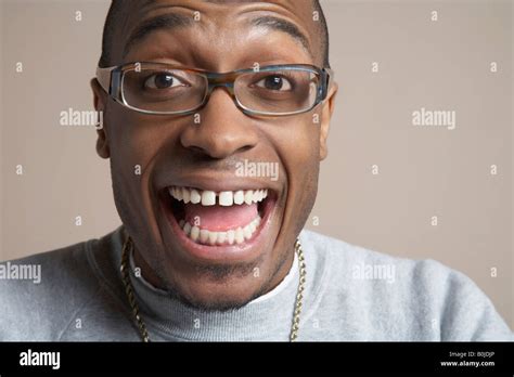 Young man laughing with mouth wide open, close-up, portrait Stock Photo - Alamy