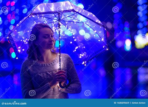 A Girl Walks through the Night City with Lights. Rainy Stock Image ...