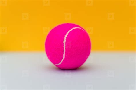 Pink tennis ball on yellow background stock photo (142782) - YouWorkForThem