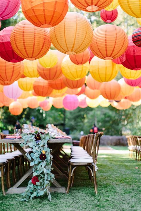 Wedding reception filled with massive amount of hanging colorful paper ...