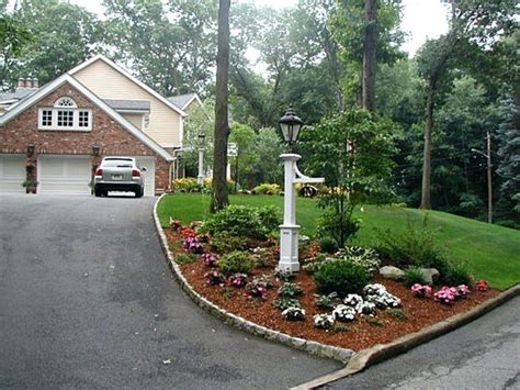 garden on slope near curb - Google Search | Driveway entrance landscaping, Landscaping entrance ...