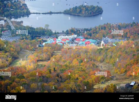 Aerial view of Lake Tremblant and Mont-Tremblant village in fall with fall foliage, from top of ...