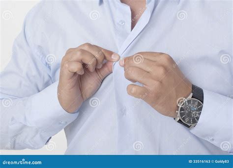 Businessman Buttoning Shirt Stock Photos - Image: 33516163