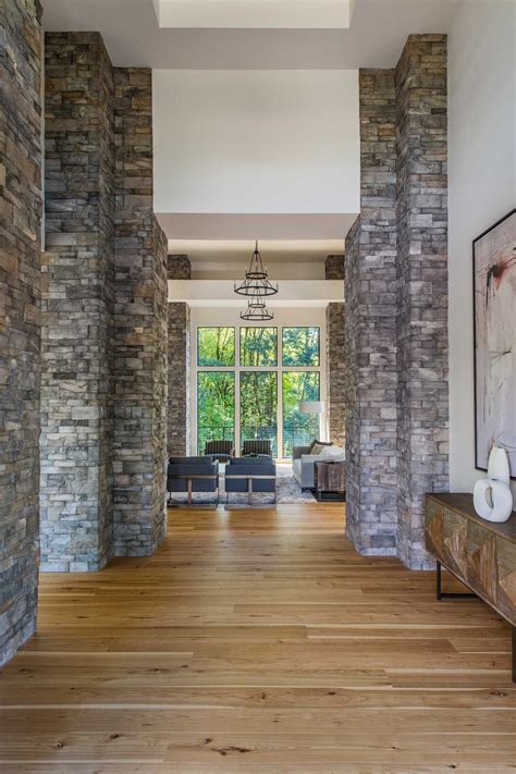 Foyer stone columns | Stone columns, Modern house, Modern mountain home