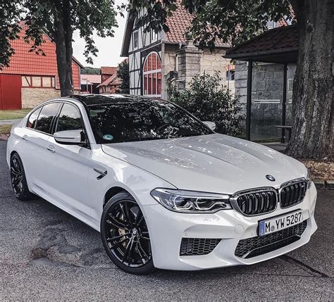 a white car parked in front of a house