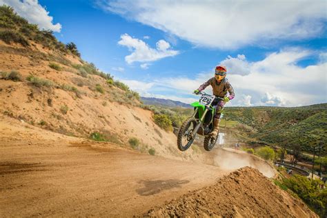 Rider Riding Green Motocross Dirt Bike · Free Stock Photo