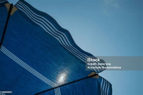 Blue Sun Umbrella On The Beach Across Blue Sky And Shining Sun Summer ...