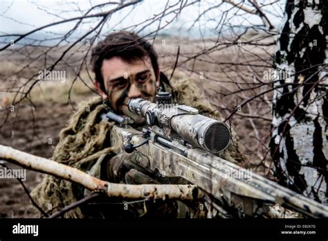 British sniper with his L115A3 long range sniper rifle on exercise in Poland nov 2014 Stock ...