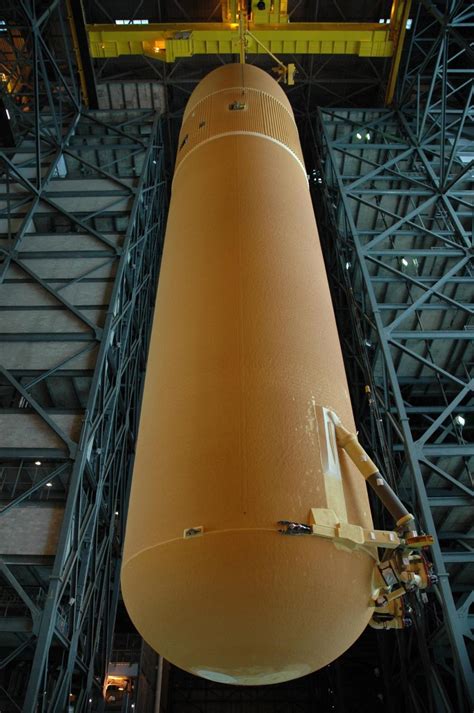 KENNEDY SPACE CENTER, FLA. -- Seen from below, external tank No. 125 is being lifted high into ...