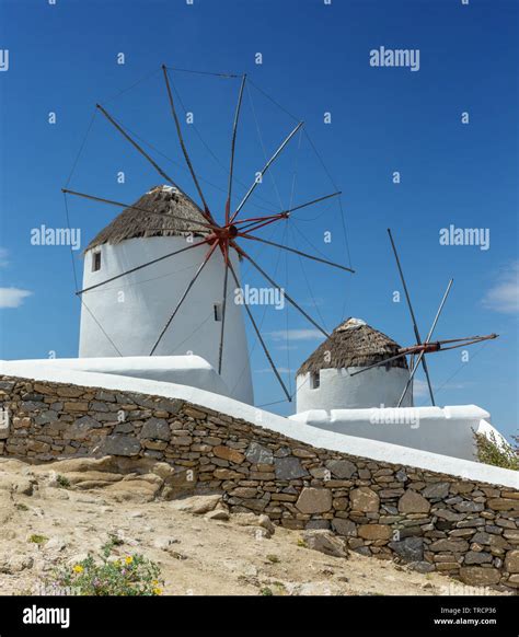 Iconic Mykonos Windmills in Greece against a blue sky Stock Photo - Alamy