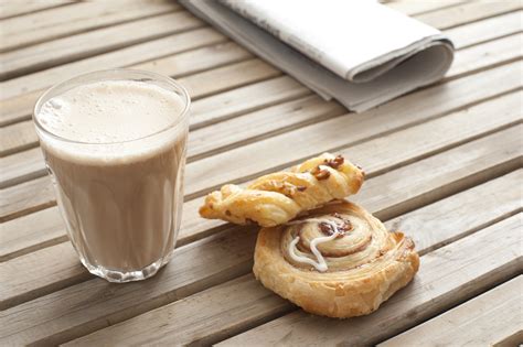 Latte coffee served with pastries - Free Stock Image