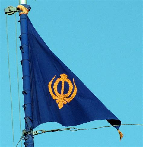 This Sikh flag, called the Nishan Sahib, is a another triangular flag ...