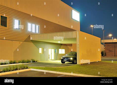 Contemporary industrial / commercial office exterior at night with parked car Stock Photo - Alamy