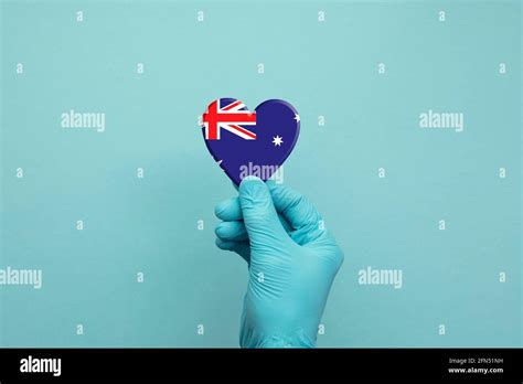 Hands wearing protective surgical gloves holding Australia flag heart Stock Photo - Alamy