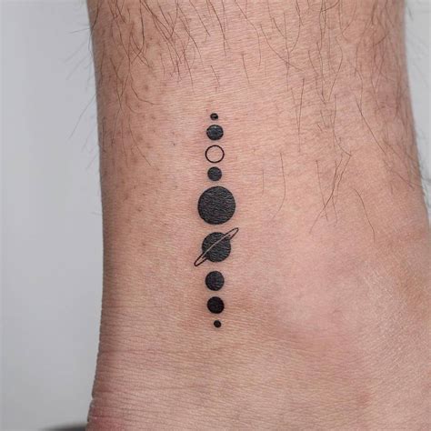 Minimalist solar system tattoo on the ankle