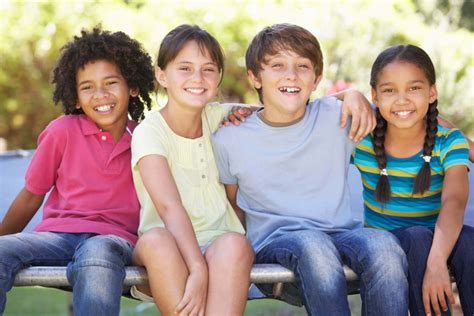 group-of-children-sitting-on-edge-of-trampoline-together-low-res - Kid Matters Counseling