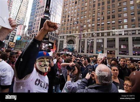 Man wearing Guy Fawkes mask at an Occupy Wall Street Protest march in Times Square, New York ...