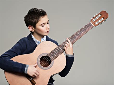 Caucasian Boy Playing on Acoustic Guitar. Stock Photo - Image of white, studio: 91771962