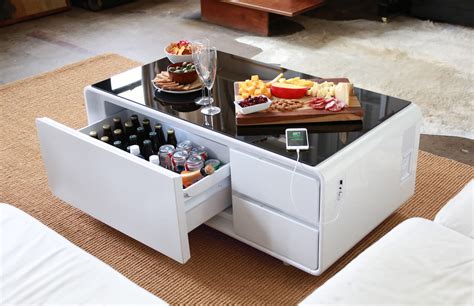 Futuristic coffee table lets you refrigerate food, play music, charge your phone at the same ...