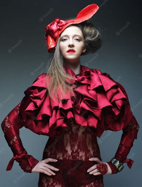 Premium Photo | Fashion model in bright red costume and red hat