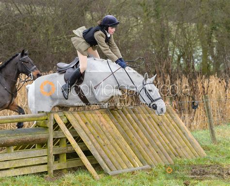 Image: jumping a hunt jump at Peakes - The Fitzwilliam Hunt visit the Cottesmore at Burrough ...