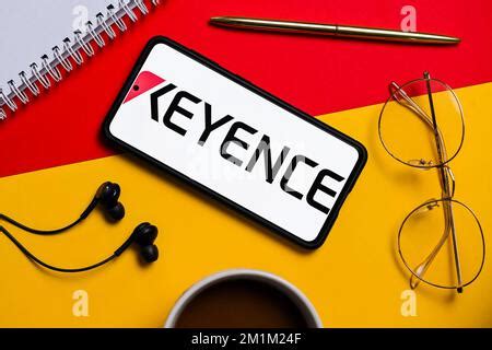 In this photo illustration a Keyence logo seen displayed on a smartphone Stock Photo - Alamy