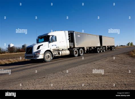 semi truck towing double trailer along highway in rural Saskatchewan Canada Stock Photo - Alamy