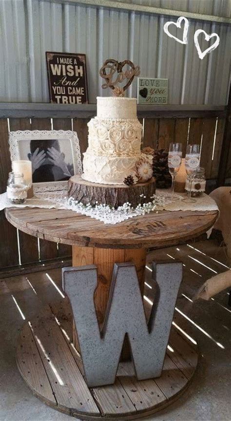 a cake sitting on top of a wooden table in front of a metal sign that ...