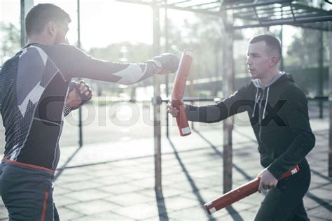 Strong boxer performing his punch while using boxing sticks | Stock ...