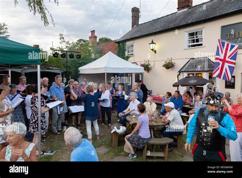 English Pub; A local choir singing outside at a pub sing out in summer, The Bull Pub, Burrough ...
