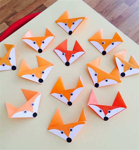 a group of paper foxes sitting on top of a table