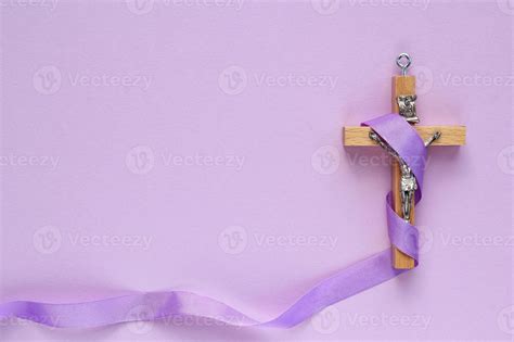 Christian religious wooden cross crucifix with violet ribbon on purple ...